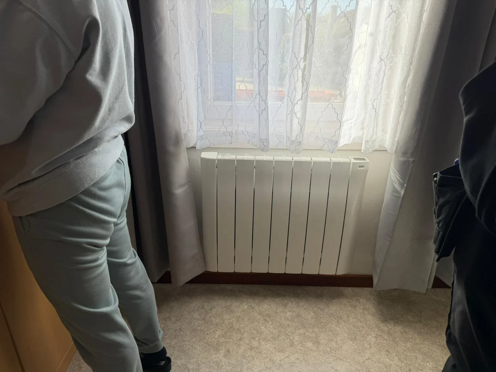 Radiateur Eco Chaleur installé sous fenêtre dans un salon clair